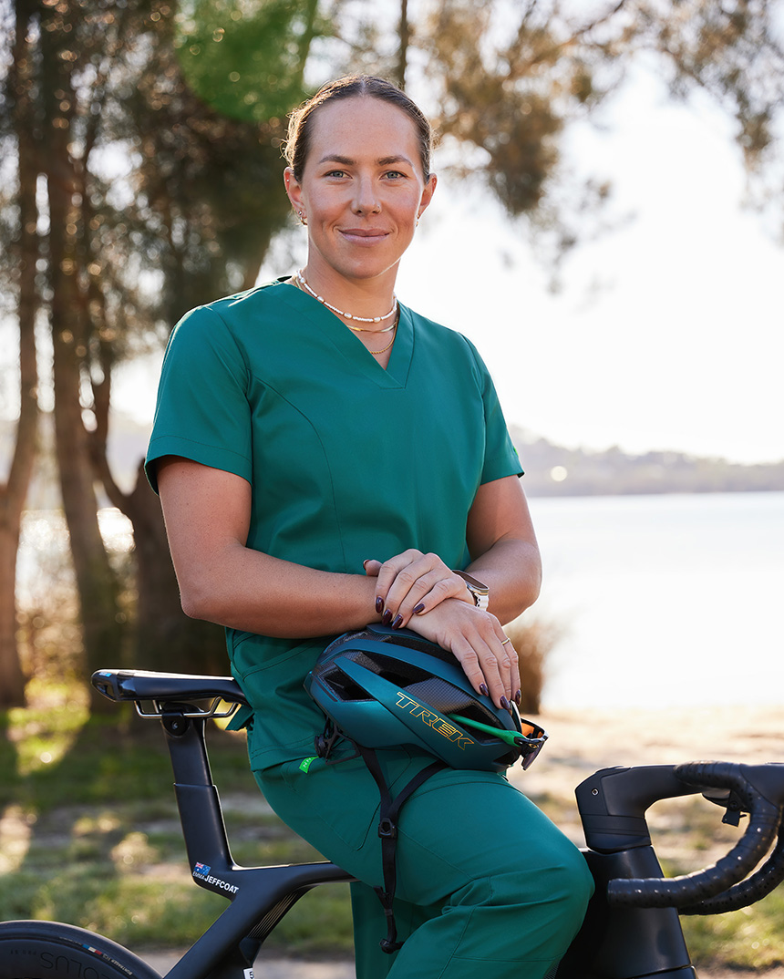 Emma Jeffcoat on bike in NNT scrubs